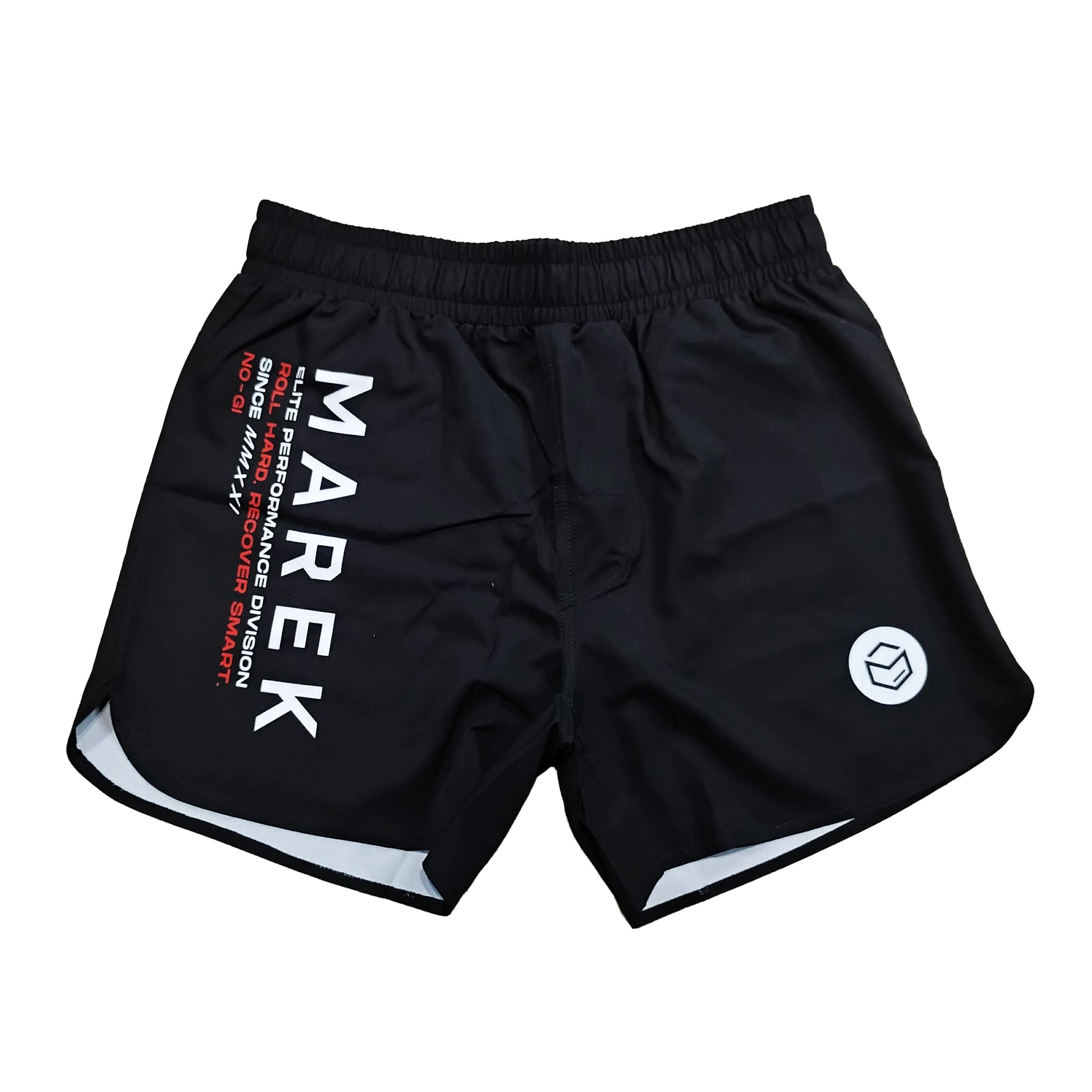 Black athletic training shorts with a white elastic waistband, featuring 'MAREK' printed vertically in white on the left leg, red text details, a white geometric logo on the right leg, and white piping along the hem.